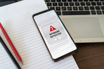 Spyware alert notification appearing on the phone while in use. Antivirus concept in action.