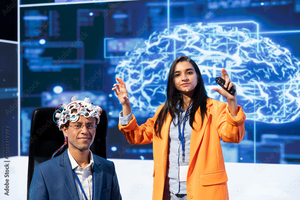 Poster portrait of specialist speaking at tech event, explaining impact of neural implants and ai technolog