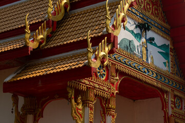 Traditional decorative ornaments and reliefs, on the roof and facade of a Buddhist temple on the island of Koh Chang, Thailand