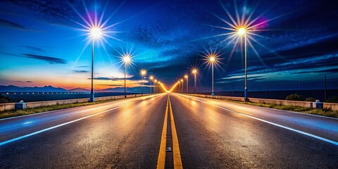 Obraz premium Road into the Distance with Streetlights Creating a Vanishing Point Effect for Urban Scenes and Landscapes