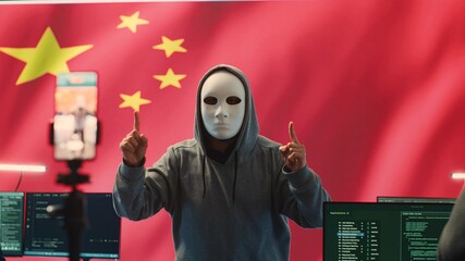 Anonymous hacker expert in a Chinese hacking high tech office, digital threats and political...