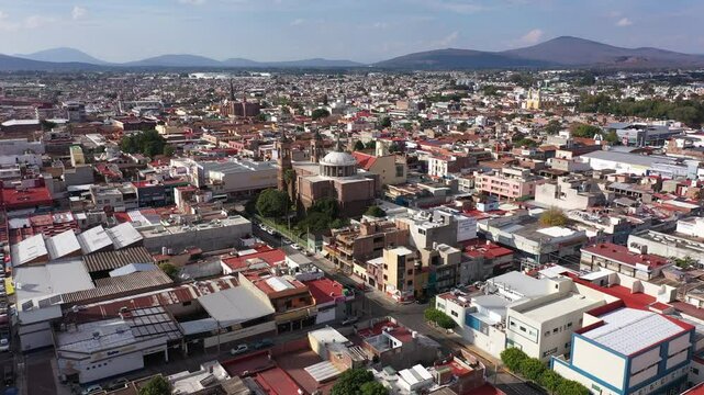 Zamora, Michoac&aacute;n, Mexico - December 24, 2023: Afternoon light shines on a historic church in the heart of downtown Zamora.