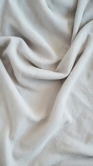Close-up of soft, velvety fabric with a smooth texture in grey tones