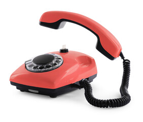 Old red telephone with rotary dial isolated on white