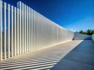 Naklejka premium Modern White Concrete Fence with Abstract Architecture and Long Exposure Shadows