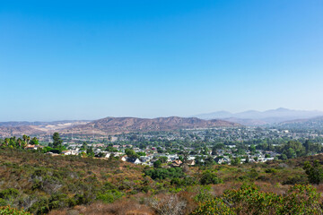 A scenic view from Big Rock Trail overlooking Santee, California, nestled among arid hills and...