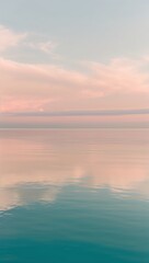 Obraz premium serene, peaceful sea, with still, mirror-like, turquoise water reflecting a warm, soft, pastel-hued sky at sunrise or sunset,