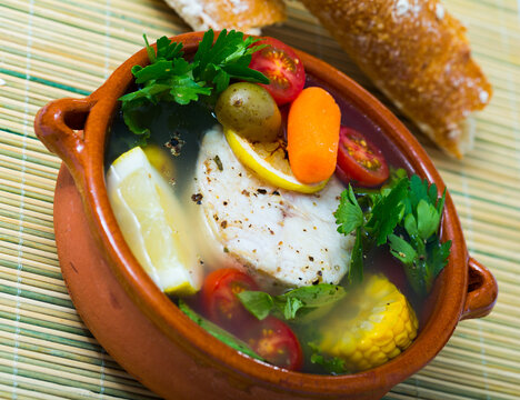 Recipe of pottage of fisherman: boil merluccius head for broth. Add potatoes, carrots, shallots, corn, fish steak 200 g, salt, pepper. Bring to oven, cook for 40min at temperature of 200 deg