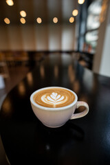 a cup of latte with a heart on it