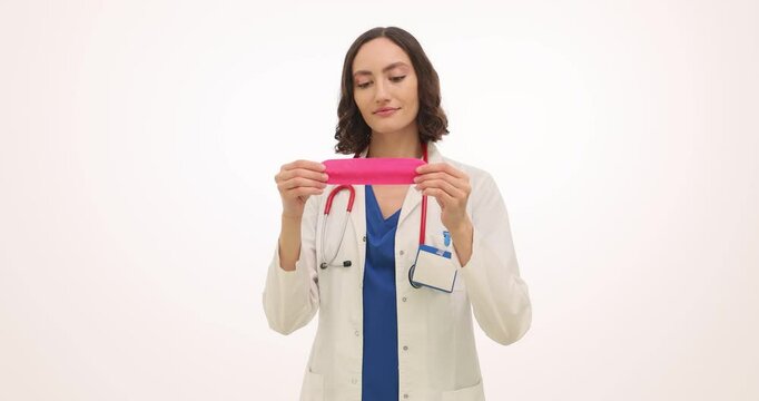 Woman doctor presents condom showing elasticity of product. Family physician demonstrates contraceptive method for teenagers focusing on flexibility
