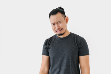 Fototapeta premium Sad crying Asian freelance man bun hair in black on white.