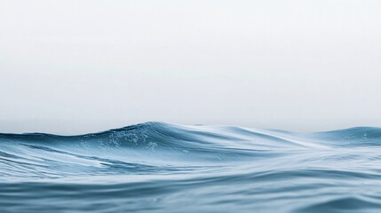 Fototapeta premium Calm ocean waves gently rolling under a clear, serene atmosphere, creating a soothing and tranquil seascape, perfect for relaxation and reflections.