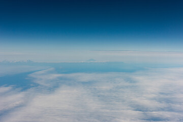 Fototapeta premium View from an airplane of the Kuril Islands and Sea of Okhotsk on a flight from Vancouver to Tokyo
