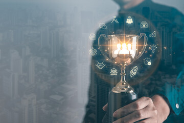 Businessman holding golden trophy for business successful with business icons.Teamwork, brainstroming, Achievement, winner and goal target concept.