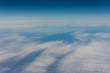 Obraz premium View from an airplane of the Kuril Islands and Sea of Okhotsk on a flight from Vancouver to Tokyo