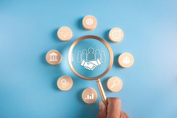 business goal achievement and objective concept.wooden block and maginfier with business icons.