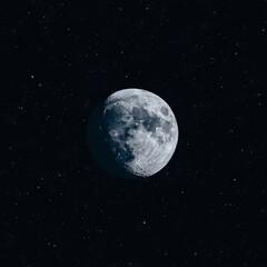Fototapeta premium A detailed view of the moon surrounded by stars in a dark sky.