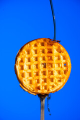 Waffle on Fork with Syrup Dripping Down