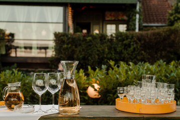A set of alcoholic drinks in front of the restaurant with several empty cups ready to be served