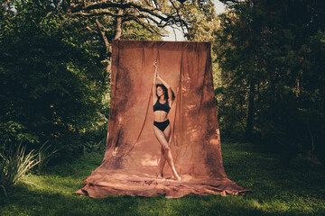 Photo of adorable cute lady wearing stylish sportswear posing outside in forest isolated on textile...