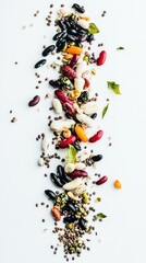A colorful assortment of various beans and seeds arranged artistically on a white background.