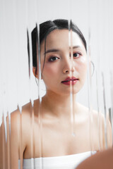 若いアジア女性の潤いのあるスキンケアイメージ