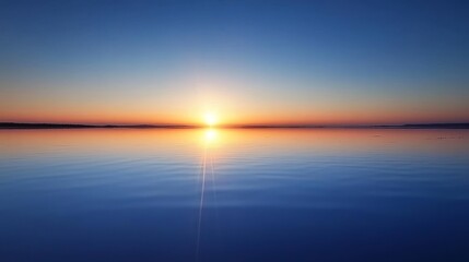 Obraz premium A serene sunset reflecting on calm waters, creating a peaceful atmosphere.