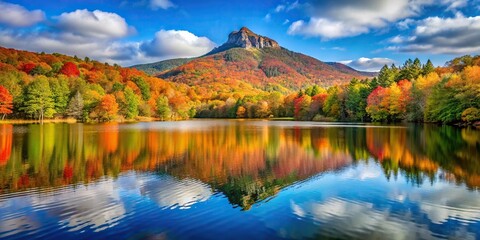 Naklejka premium Scenic view of Julian Price Lake and Grandfather Mountain during autumn season with a tilted angle