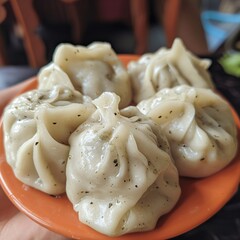 Delicious assortment of khinkali, manti, and pelmeni on a wooden platter, showcasing traditional Asian dumplings filled with meat and vegetables, perfect for a homemade meal.