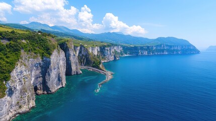 Fototapeta premium A stunning coastal view featuring dramatic cliffs, turquoise waters, and lush greenery under a bright blue sky.