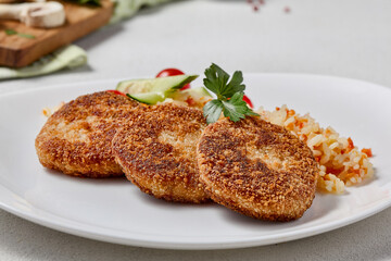 Close-Up of Juicy Turkey Cutlets with Rice and Vegetables on Elegant White Plate