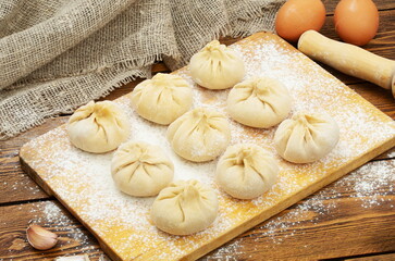 Khinkali with meat frozen on a wooden board