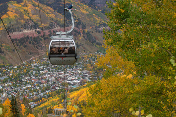 Descending into Autumn: A gondola ride into the heart of Telluride, where golden Aspen leaves paint...