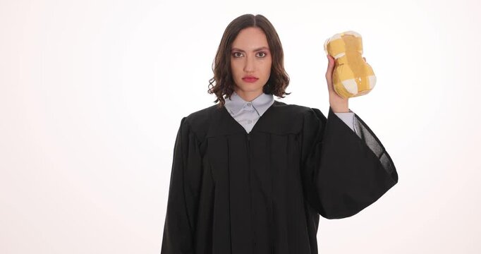 Female judge holds handcuffs and narcotics pack on white background. Woman officer demonstrates legal punishment for drug trafficking