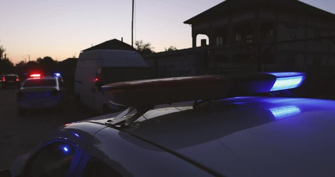Details with the red and blue lights of a police car during a police raid.