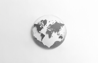 Fototapeta premium A simple, minimalist depiction of the world map in grayscale, rendered as a sphere against a white background.