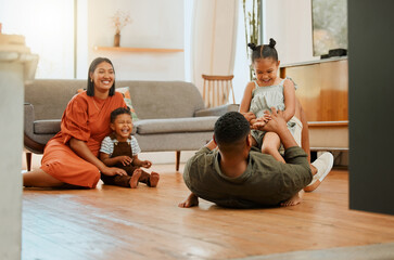 Funny, playful and bonding with family on floor in lounge for love, game and happiness together....
