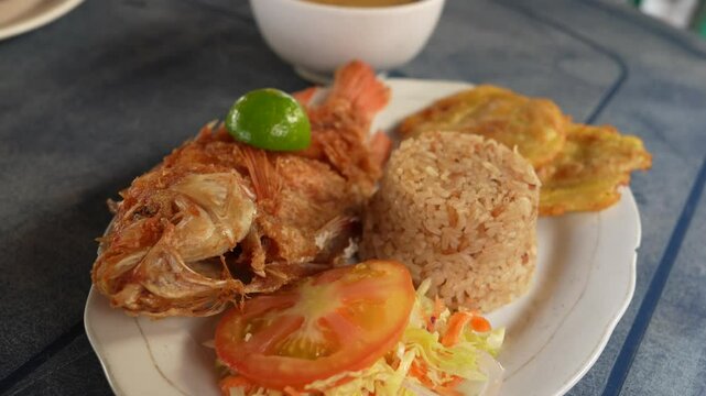 Colombian Fried Fish Served with Coconut Rice, Salad and Fried Plantain