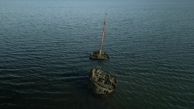 Drone shot shipwreck in ocean. Historic old boat sinking in sea water