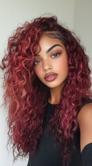 Fototapeta premium beautiful model with very curly burgundy colored hair
