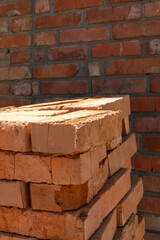 Pile of a bricks against brick wall	