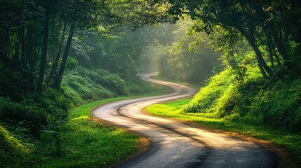 Obraz premium Tranquil Road Surrounded by Vibrant Green Foliage