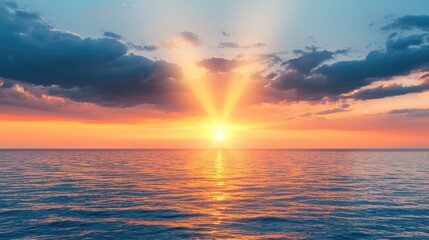 Obraz premium A serene sunset over the ocean, with vibrant colors illuminating the sky and reflections on the water's surface.