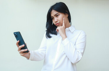 image of contemplating asian young business woman using smartphone, seriously read news and...