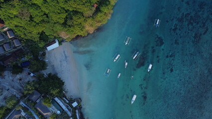 Aerial view of tropical coastline with local boats mored 