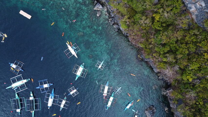 Aerial view of coastline with local boats mored 