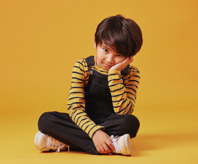 Bored, lonely and portrait with Asian boy on yellow background, isolated in studio for growth....