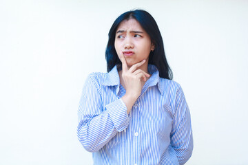 confused asian woman look thoughtful wearing striped shirt isolated on white background