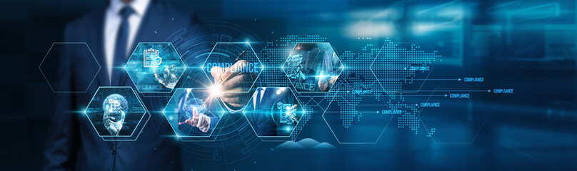 Businessman using tablet analyzing compliance regulations, market trends, customer feedback,...