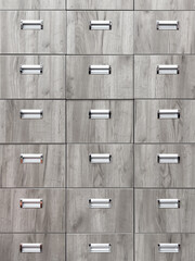 A row of wooden drawers with metal handles